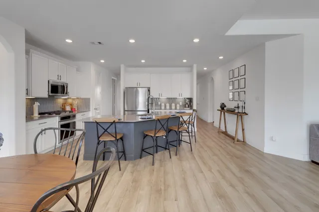 a view of a dining room with furniture and wooden floor