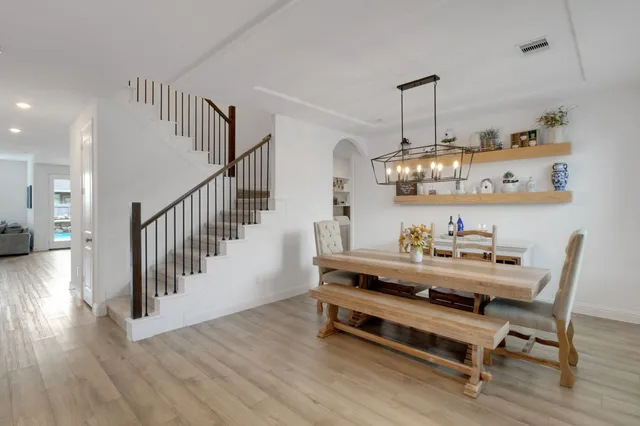 a dining room with furniture and wooden floor