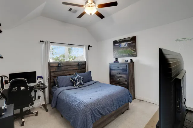 a bedroom with a bed and dresser