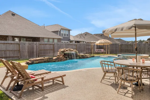 a view of a house with backyard and sitting area