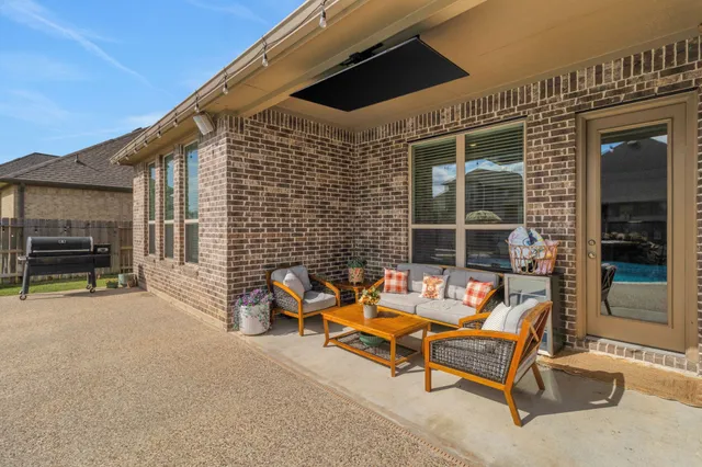 a backyard of a house with outdoor seating