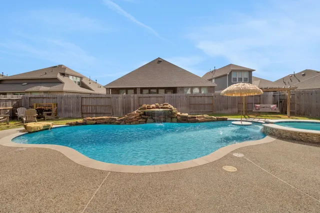 a view of a big house with a big yard and potted plants