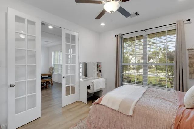 a bedroom with a large bed and a large window