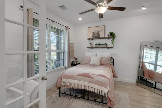 a bedroom with a bed and a chandelier
