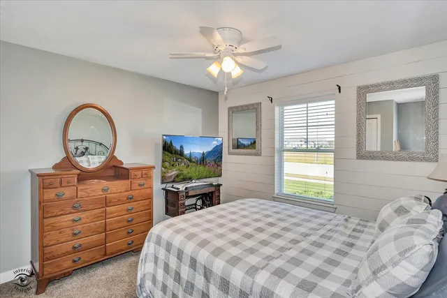 a bed room with a bed and a television