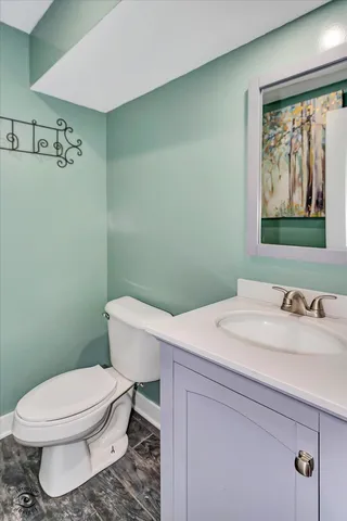 a bathroom with a sink a toilet and mirror