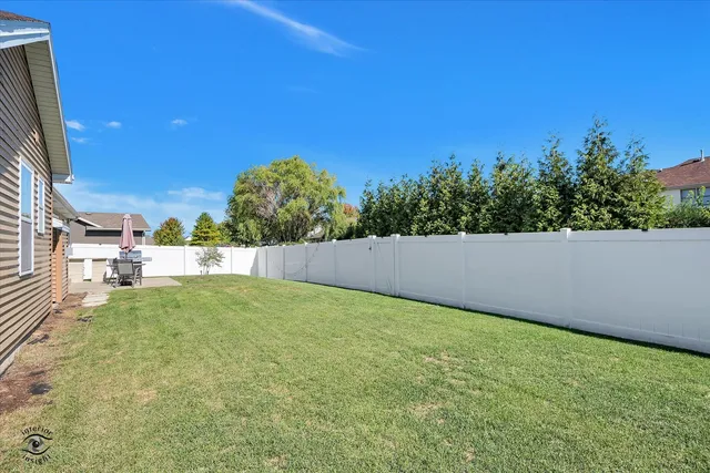 a view of backyard with swimming pool and outdoor seating