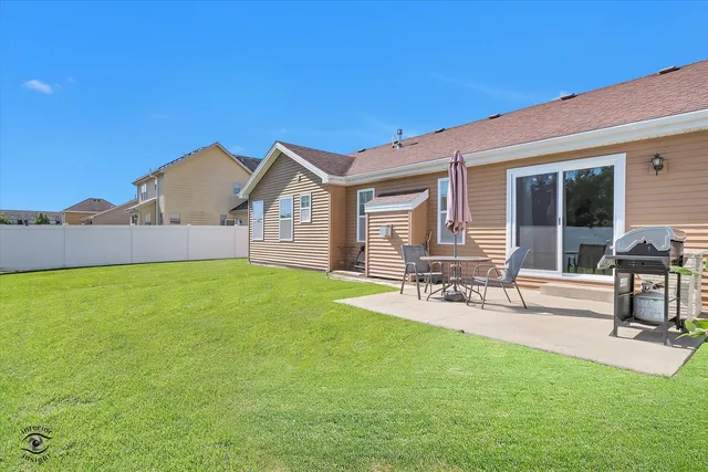 a view of house with a backyard porch and sitting area