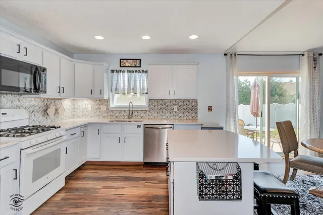 a kitchen with a stove a sink and a refrigerator