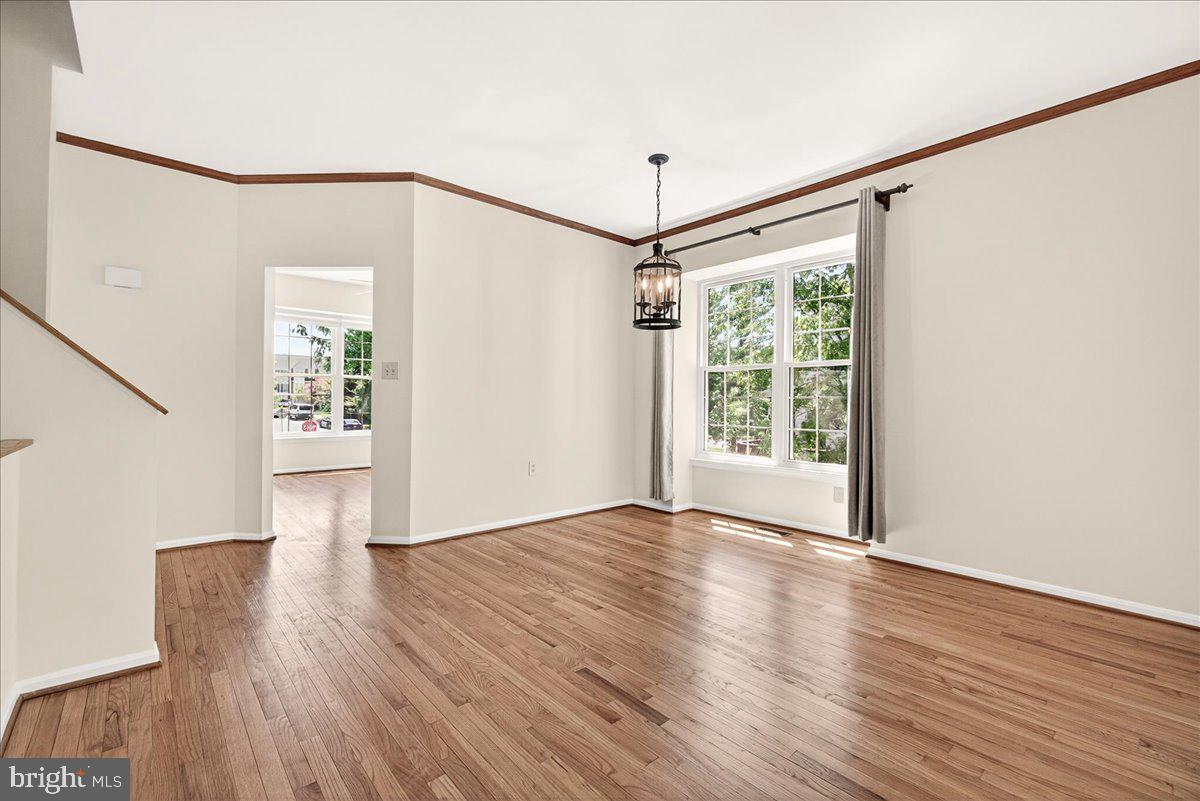 111 Water Land Way Frederick, MD 21702 - Photo 12 of 35 a view of an empty room with wooden floor and a window