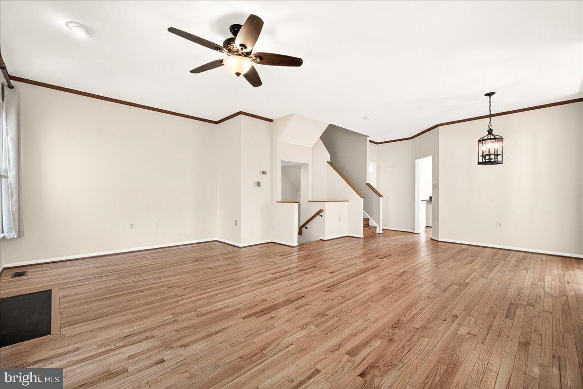 111 Water Land Way Frederick, MD 21702 - Photo 14 of 35 a view of empty room with wooden floor and fan