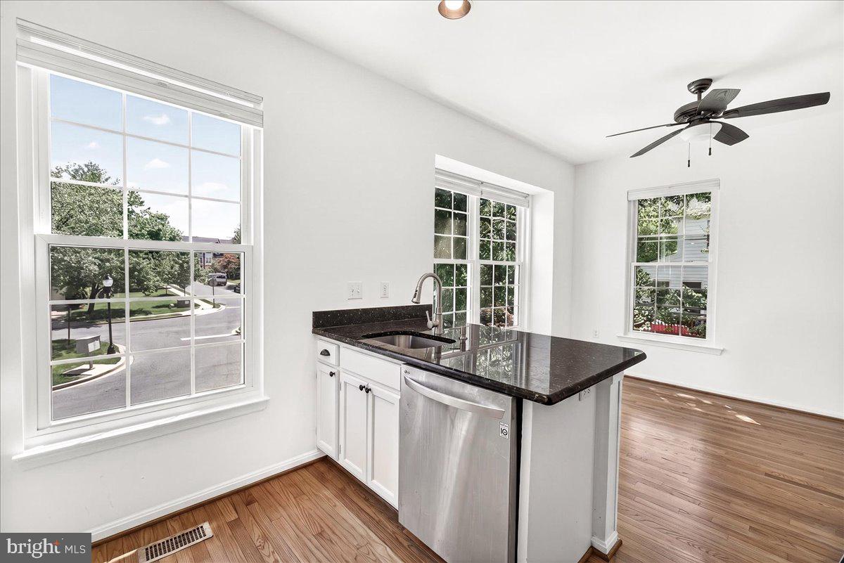 111 Water Land Way Frederick, MD 21702 - Photo 21 of 35 a kitchen with granite countertop a stove a sink and a window