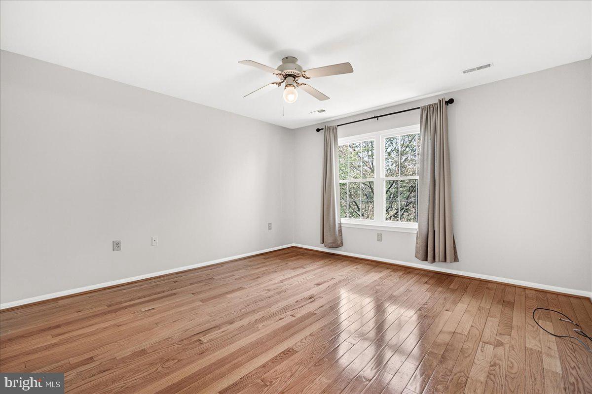 111 Water Land Way Frederick, MD 21702 - Photo 25 of 35 a view of an empty room with wooden floor and a window