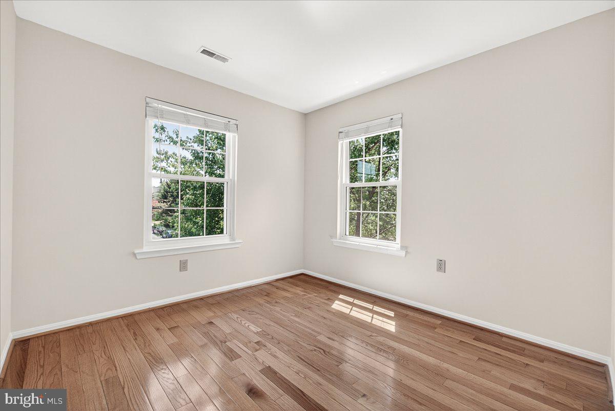 111 Water Land Way Frederick, MD 21702 - Photo 30 of 35 an empty room with wooden floor and windows