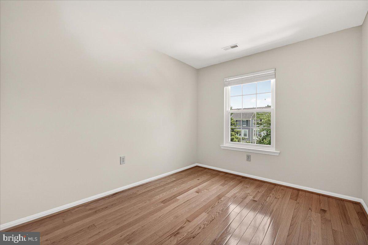 111 Water Land Way Frederick, MD 21702 - Photo 31 of 35 an empty room with wooden floor and windows