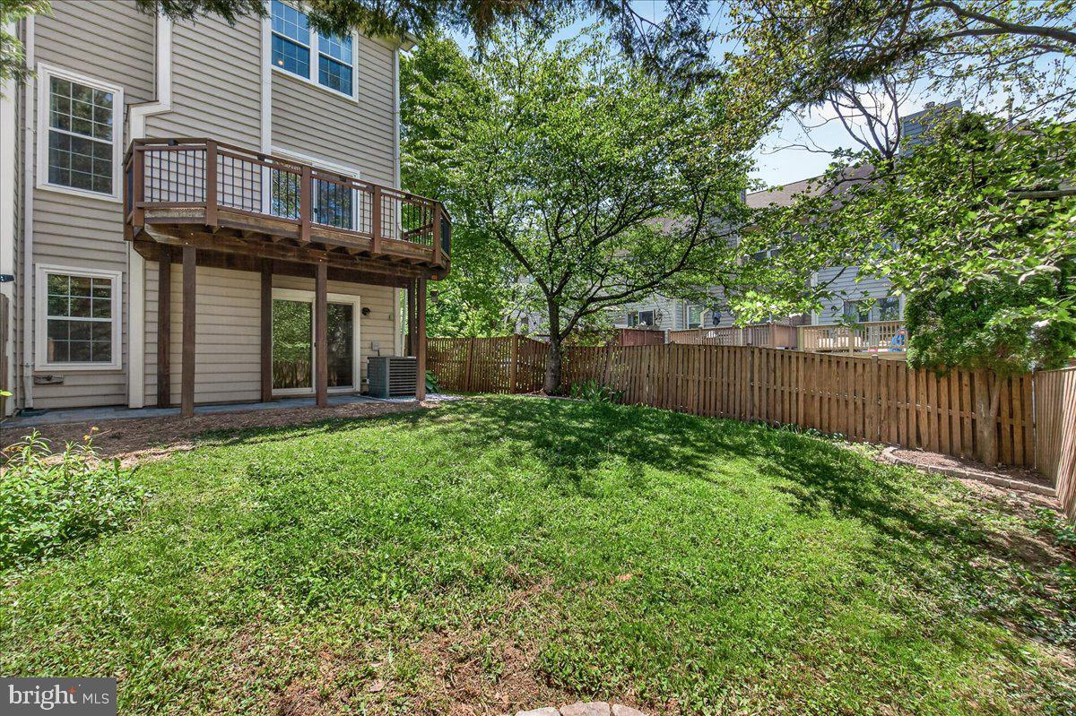 111 Water Land Way Frederick, MD 21702 - Photo 33 of 35 a view of a house with a small yard and a large tree