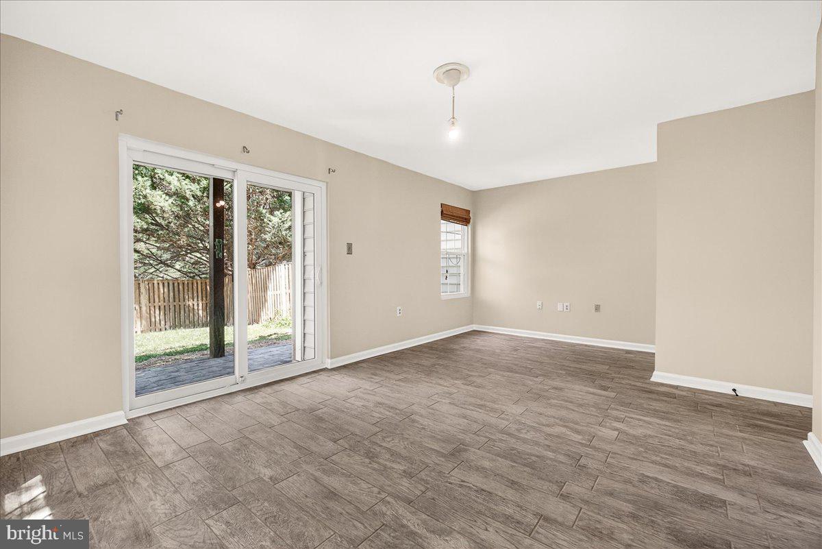 111 Water Land Way Frederick, MD 21702 - Photo 7 of 35 a view of an empty room with wooden floor and a window