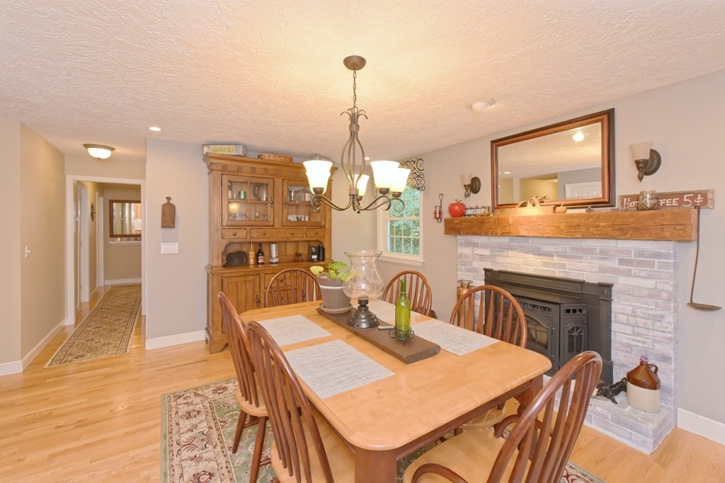 25 Edward Road Mendon, MA 01756 - Photo 11 of 42 a dining room with furniture a chandelier and wooden floor