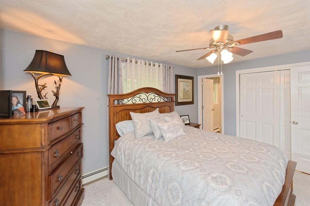 25 Edward Road Mendon, MA 01756 - Photo 17 of 42 a bedroom with a bed and a chandelier