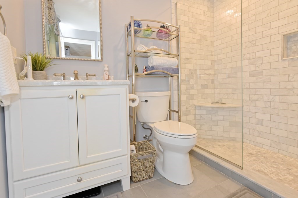 25 Edward Road Mendon, MA 01756 - Photo 19 of 42 a bathroom with a sink a toilet and shower