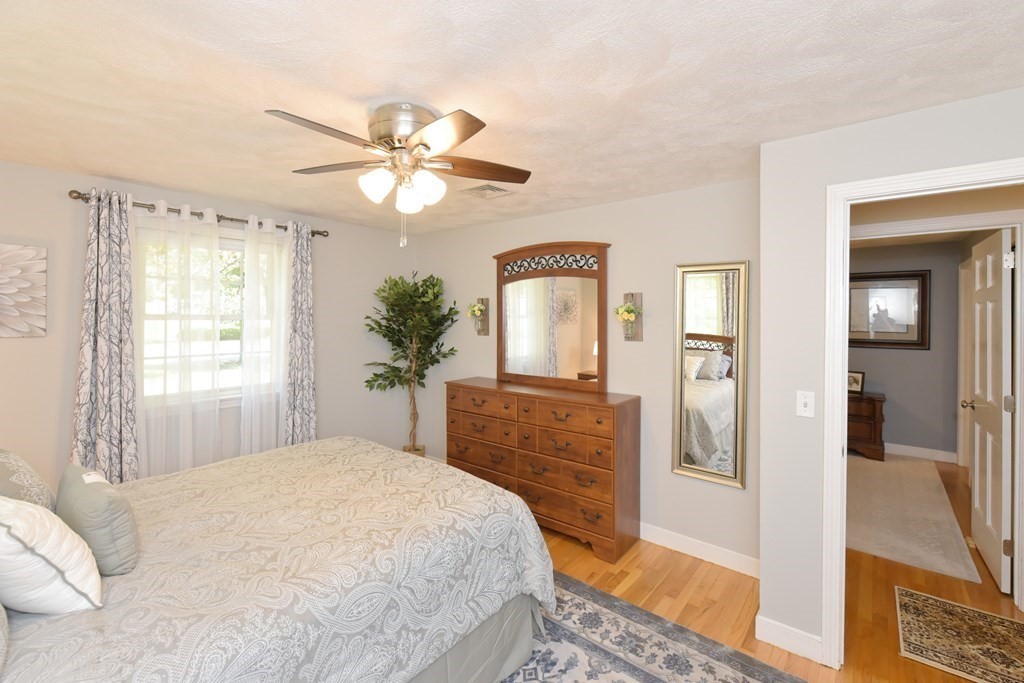 25 Edward Road Mendon, MA 01756 - Photo 23 of 42 a bedroom with a bed chandelier and a window