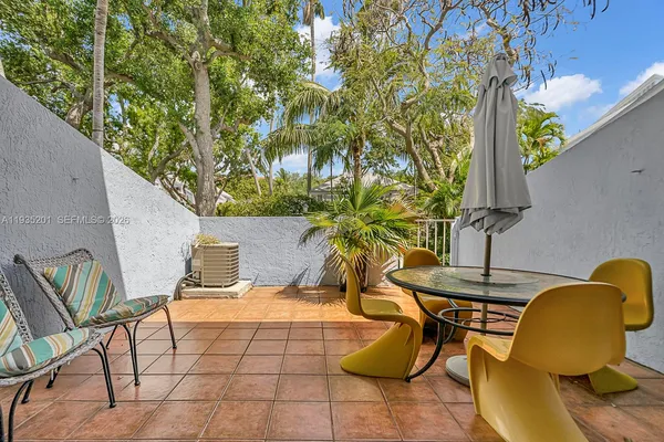 a balcony with table and chairs