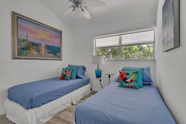a bedroom with two beds and a window