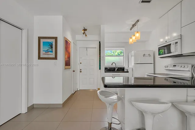 a kitchen with stainless steel appliances a sink and a refrigerator