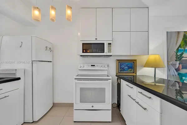 a kitchen with cabinets stainless steel appliances and a counter space