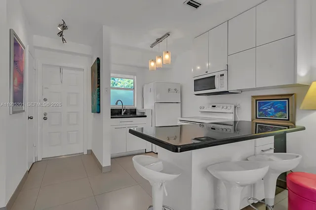 a kitchen with stainless steel appliances granite countertop a sink a stove and cabinets