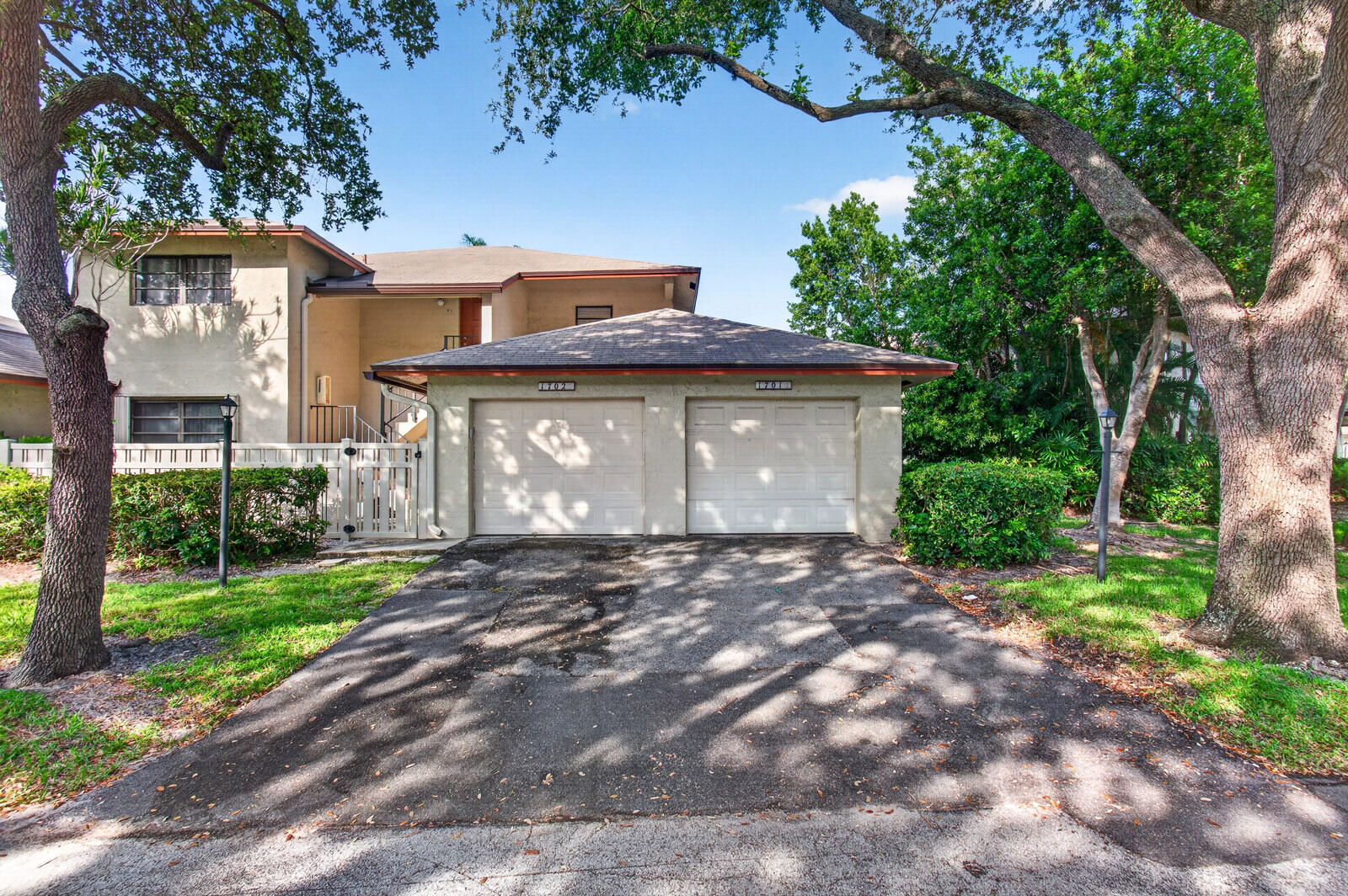 3951 Northeast 19th Road, Unit 1701 Pompano Beach, FL 33064 - Photo 65 of 82 a front view of a house with a garden and tree
