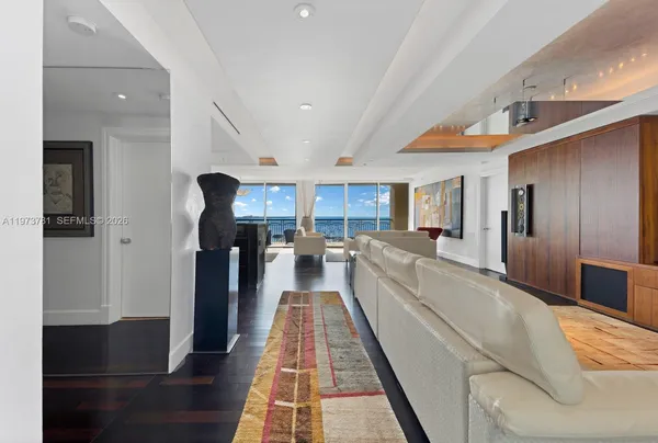 a large open kitchen with stainless steel appliances kitchen island granite countertop a refrigerator and a sink
