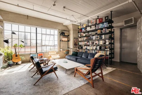 a reading room with furniture and a book shelf