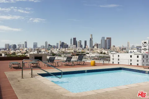 a view of a terrace with chairs and barbeque