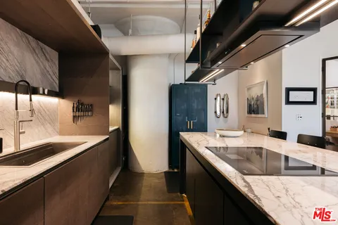 a kitchen with stainless steel appliances granite countertop sink and stove