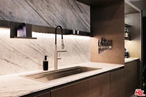 a kitchen with kitchen island a sink and refrigerator