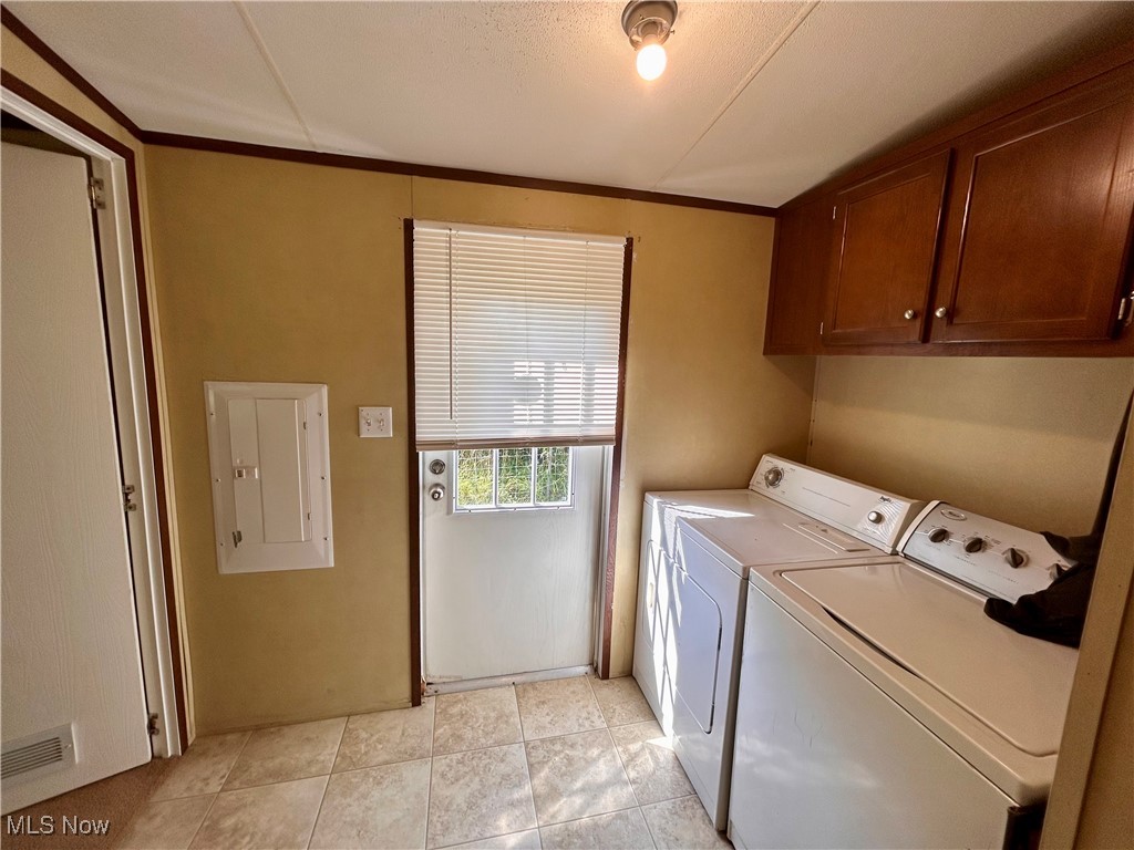 84550 Snyder Road Jewett, OH 43986 - Photo 14 of 21 Washroom with separate washer and dryer, cabinet space, crown molding, and electric panel