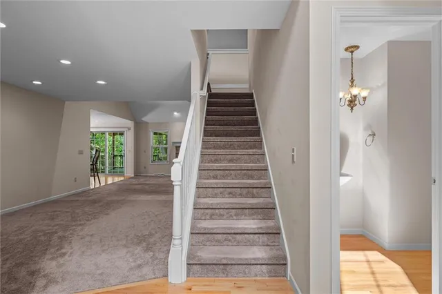 a view of a livingroom with wooden floor and stairs