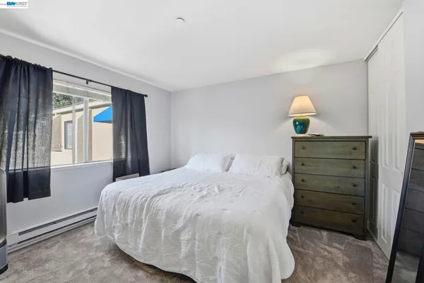 a bedroom with a bed and a lamp on table