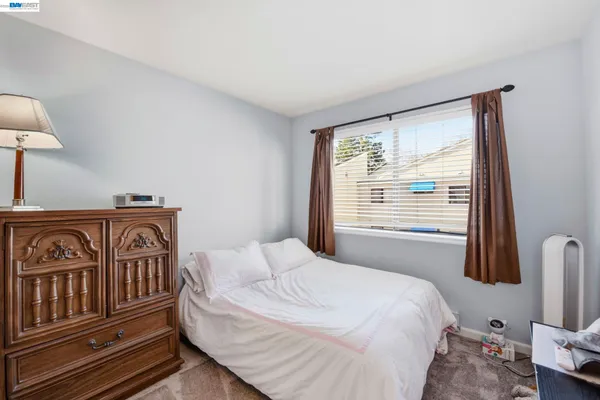 a bedroom with a bed and a table in it