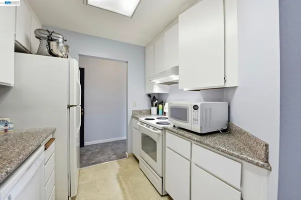 a kitchen with a stove and a refrigerator