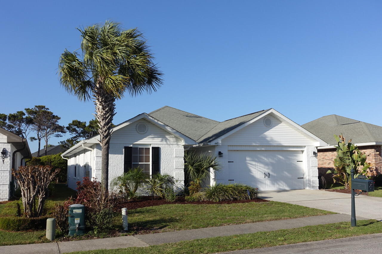 440 Sandy Cay Drive Miramar Beach, FL 32550 - Photo 32 of 48 a front view of a house with a yard and garage