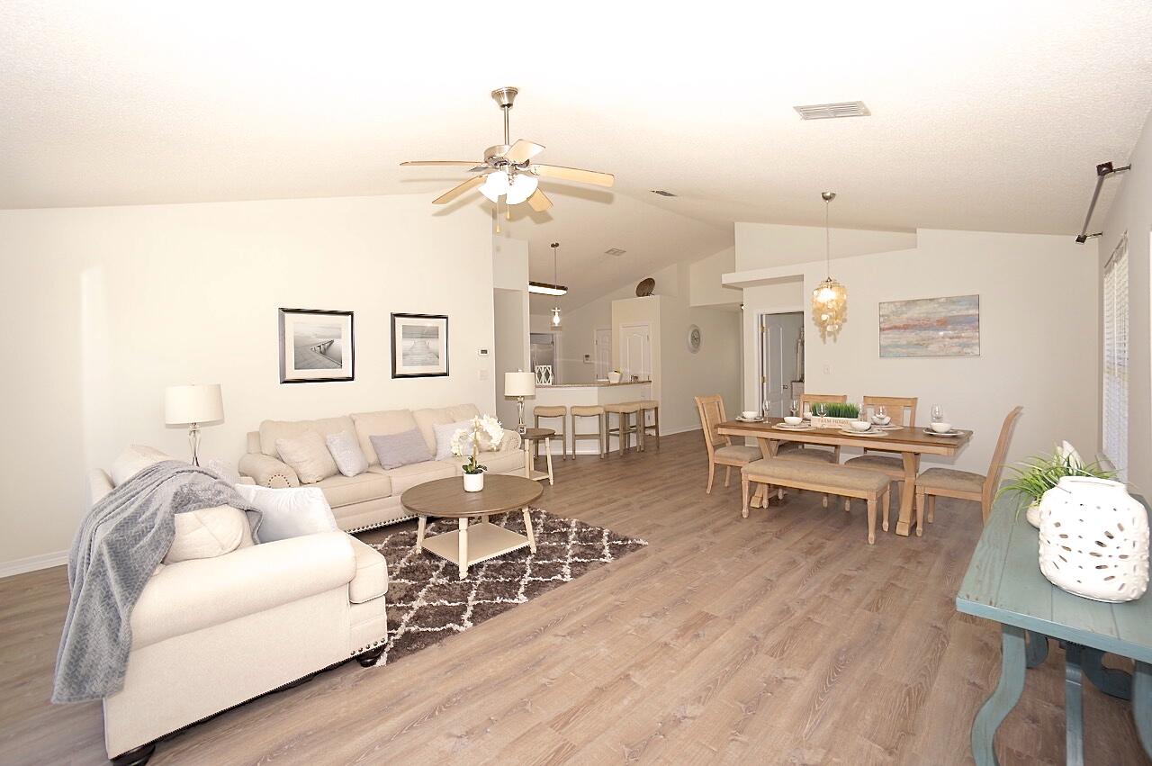 440 Sandy Cay Drive Miramar Beach, FL 32550 - Photo 9 of 48 a living room with lots of furniture and a chandelier