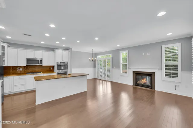 a kitchen with a refrigerator and a stove top oven