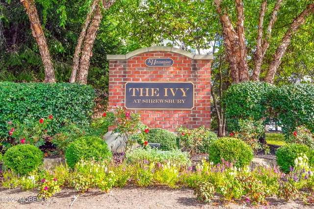 a sign broad in front of flowers