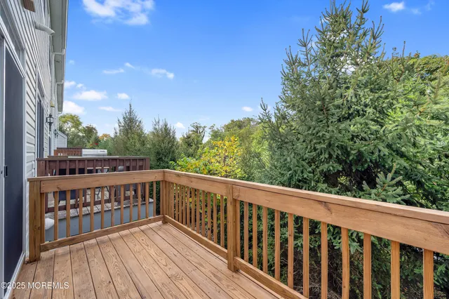 a view of balcony with wooden floor and fence