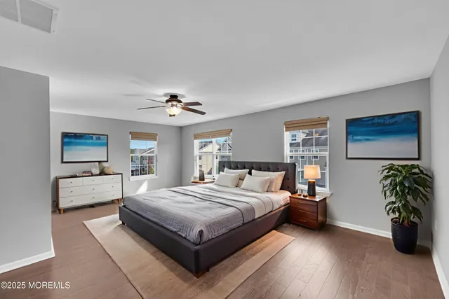 a bedroom with a bed and a potted plant