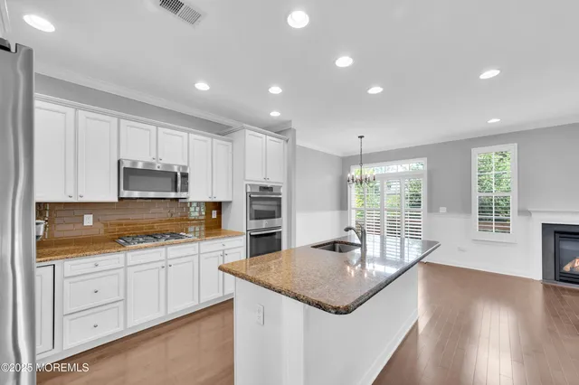 a kitchen with a sink stove and cabinets
