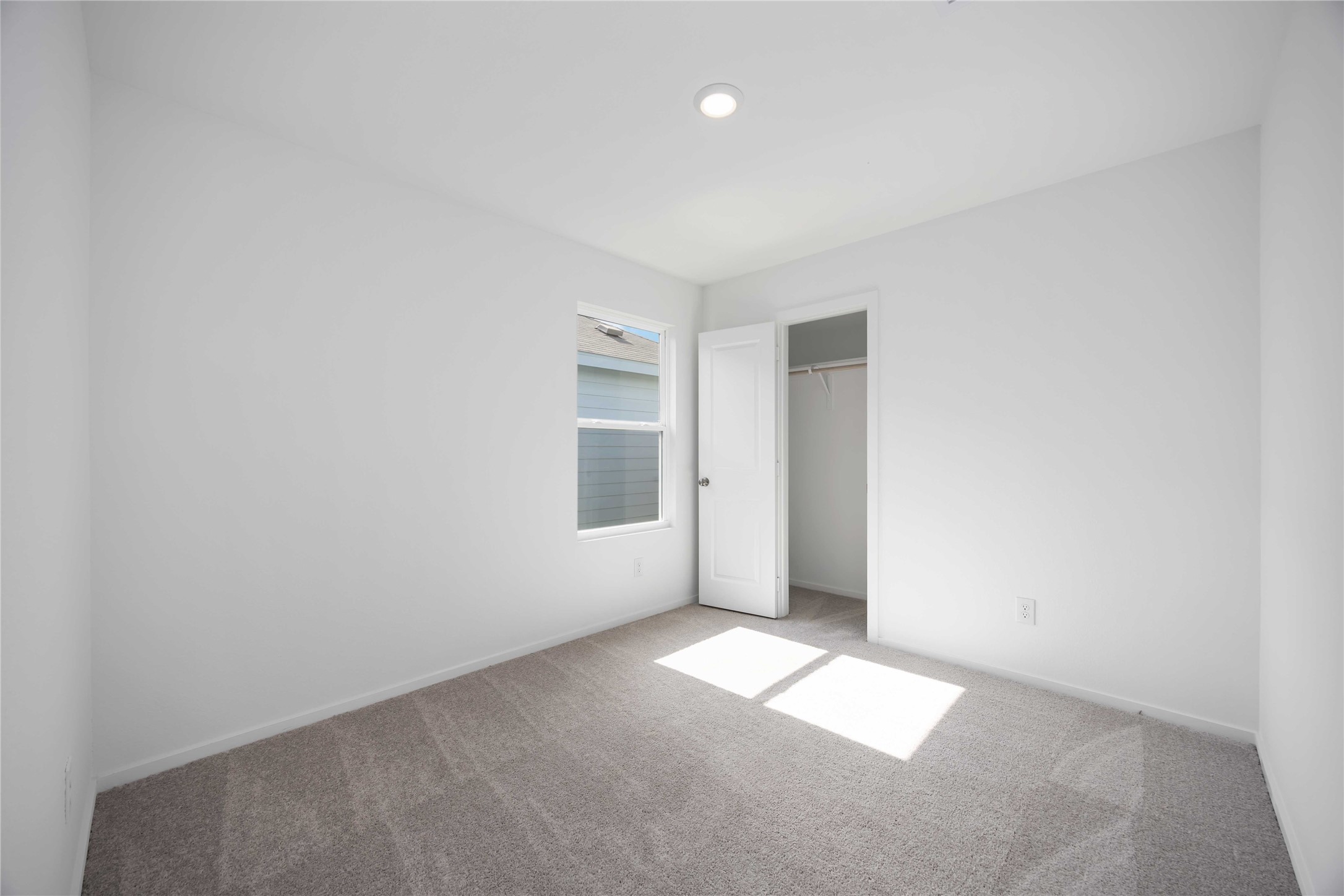385 Lucia Way Cleveland, TX 77327 - Photo 20 of 30 an empty room with windows