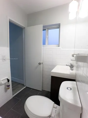 a bathroom with a sink a toilet and tub